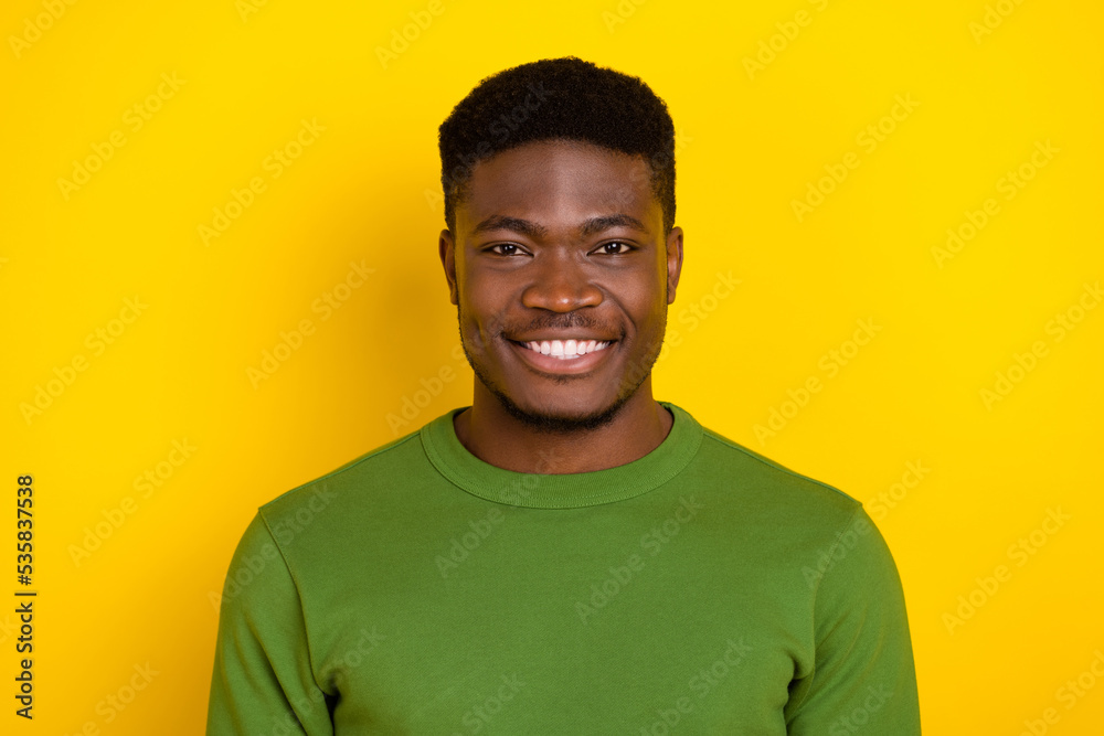 Portrait of attractive cheerful brunet guy wearing pullover isolated on bright yellow color background