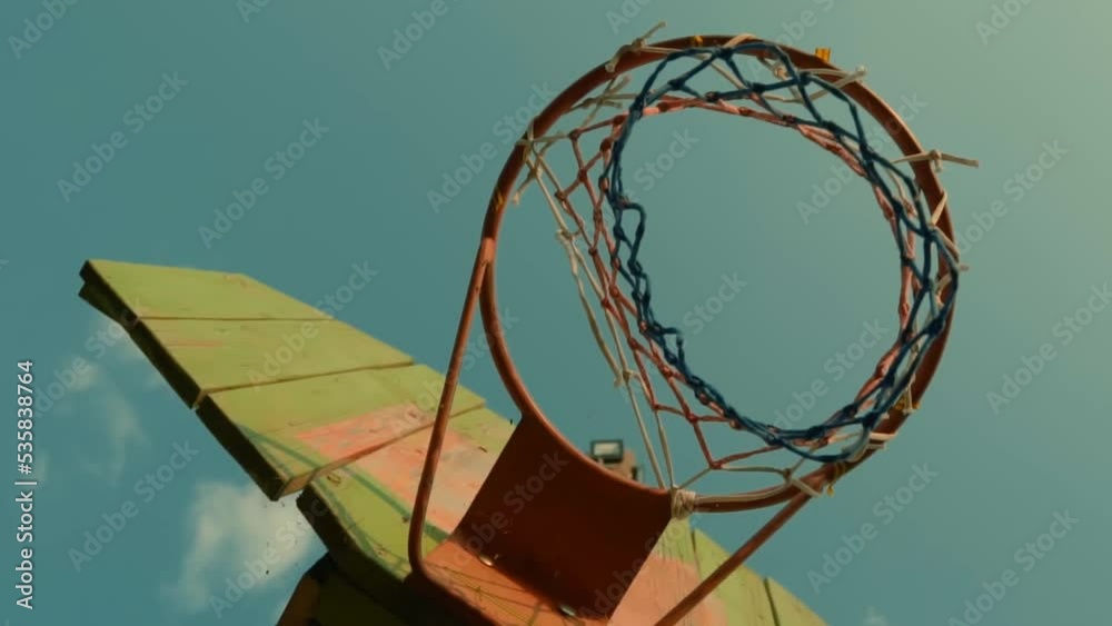 Closeup Portrait of Old Basketball Hoop Outdoors on the Court. Old Basketball Hoop in Sun Rays. Basketball Hoop in the Ghetto Closeup Portrait of Old Basketball Hoop Outdoors on the Court. Old Basketball Hoop in Sun Rays. Basketball Hoop in the Ghetto