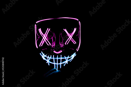 Purple and blue Halloween led mask with black background
