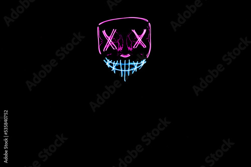 Purple and blue Halloween led mask with black background
