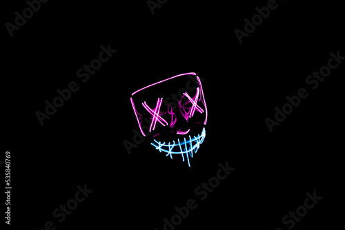 Purple and blue Halloween led mask with black background
