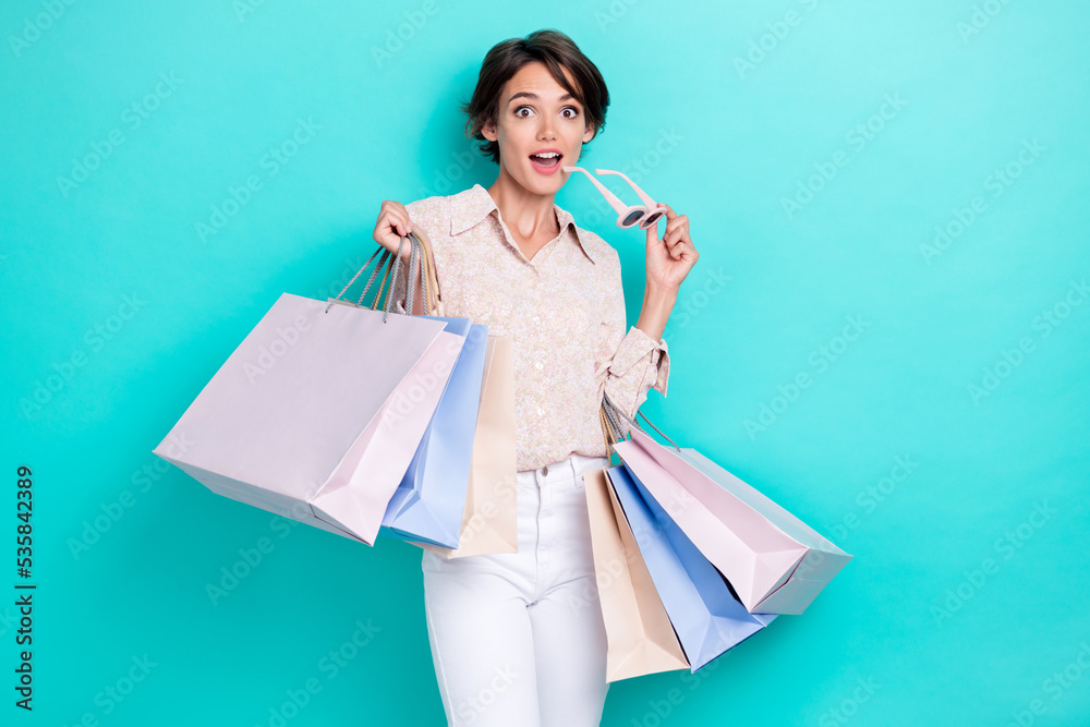 Photo of astonished lady hand hold bag eyewear unexpected unbelievable sale trendy collection low price isolated on cyan color background Photo of astonished lady hand hold bag eyewear unexpected unbelievable sale trendy collection low price isolated on cyan color background