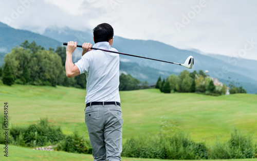 Man golf player swinging golf club