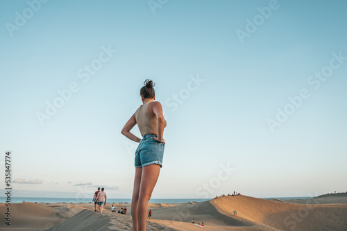 Tourist contemplating the people on Maspalomas desert photo