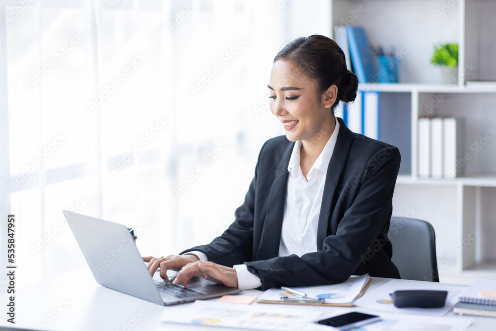 Asian female accountant or banker making calculations. Young business asian woman in workplace, Documents, tax, report for analysis Savings, finances and economy concept. Asian female accountant or banker making calculations. Young business asian woman in workplace, Documents, tax, report for analysis Savings, finances and economy concept.