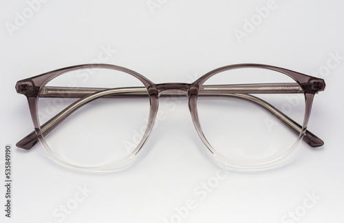 Eyeglass frames, lenses, various colors, both metal and plastic, on a beautiful colored background.