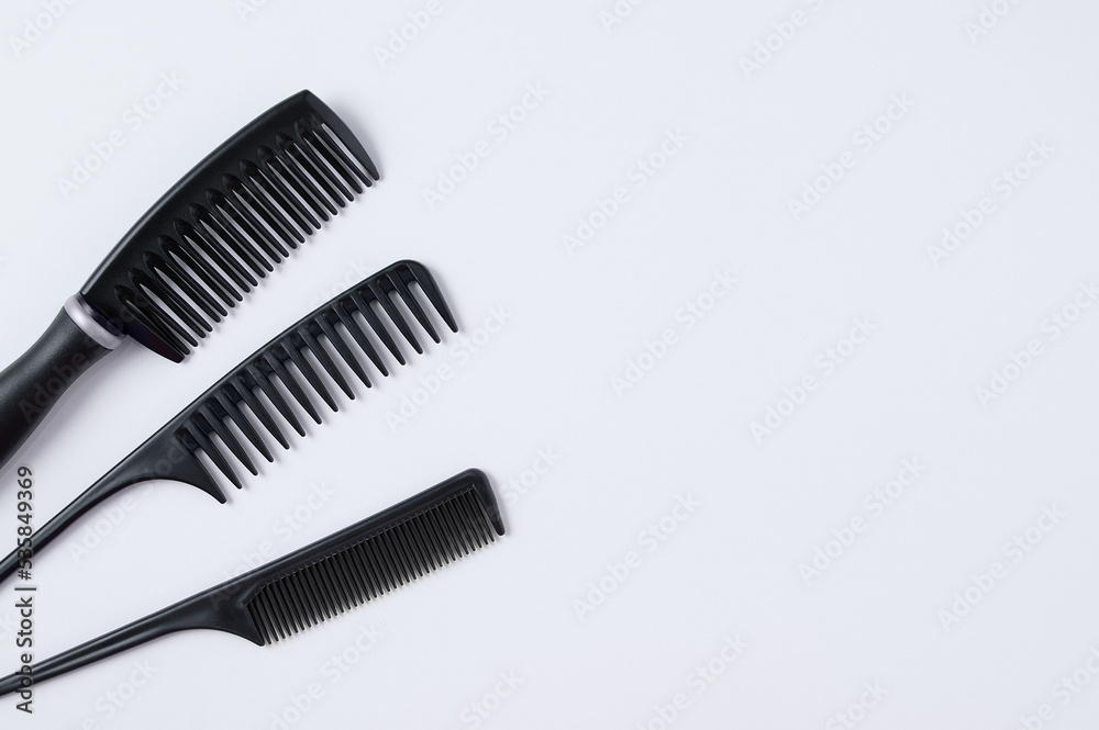 Three black hair combs. White background. Place text. Three black hair combs. White background. Place text.