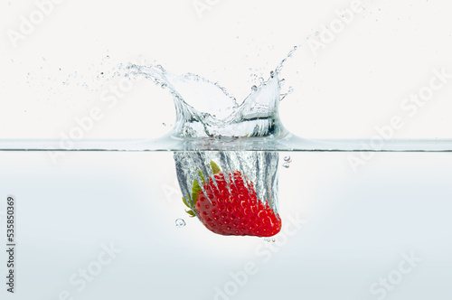 Strawberry splashing in water. photo