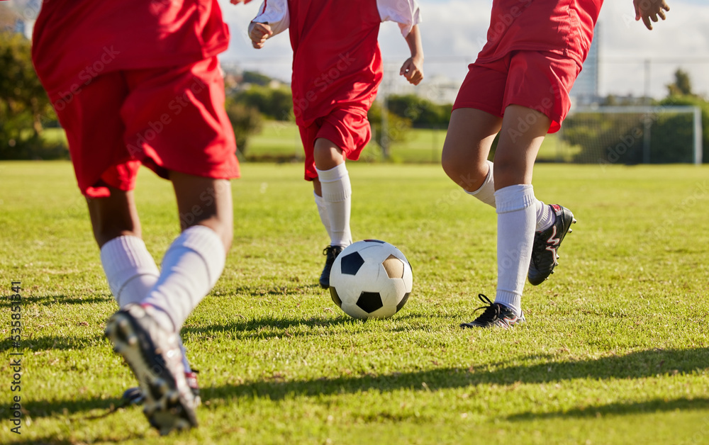 Obraz premium Kids team, soccer or legs with soccer ball in workout, fitness game or exercise on nature park grass, high school stadium or field. Football or sports training with energy in health or girls wellness