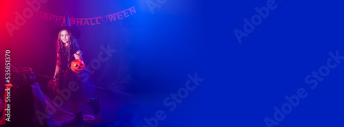 Banner funny child girl in witch costume for Halloween with pumpkin Jack copy space