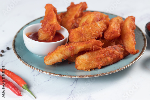 Potatos wedges with tomato sauce served in dish isolated on background side view of fastfood