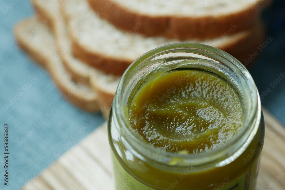 kaya spread in a container and bread on table , kaya spread in a container and bread on table ,
