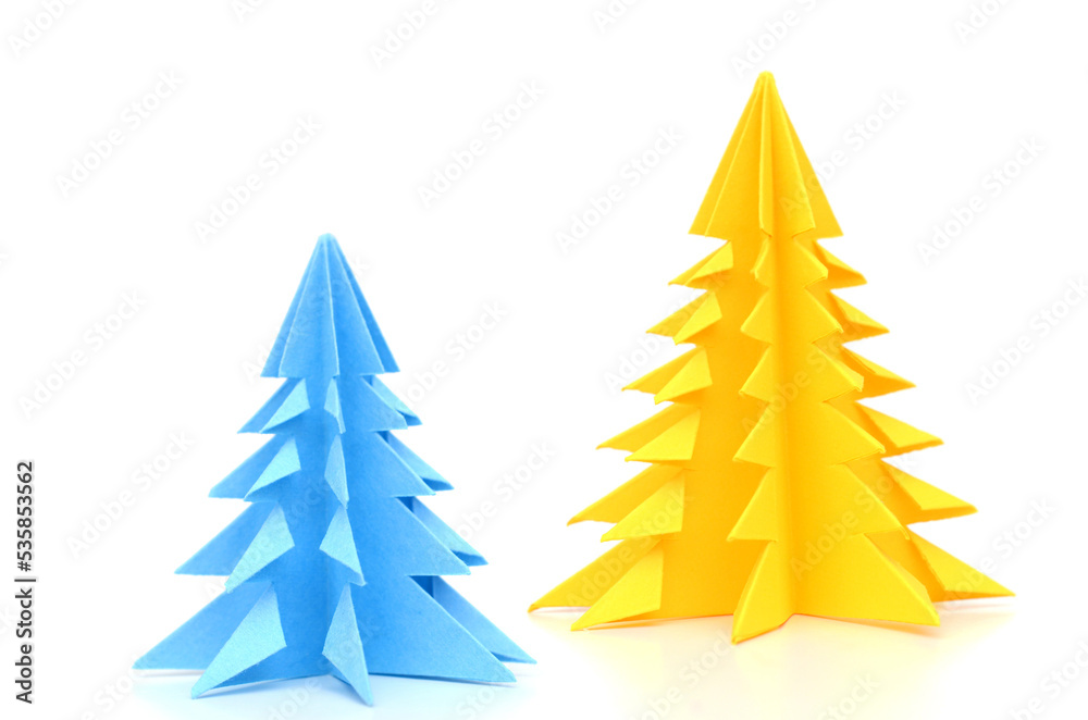 Obraz premium Two paper christmas trees on white
