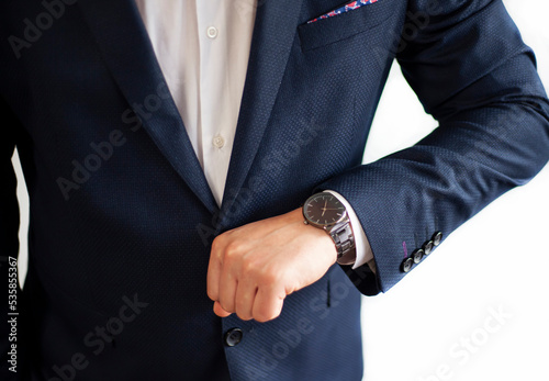 Businessman look at the clock, isolated on white background