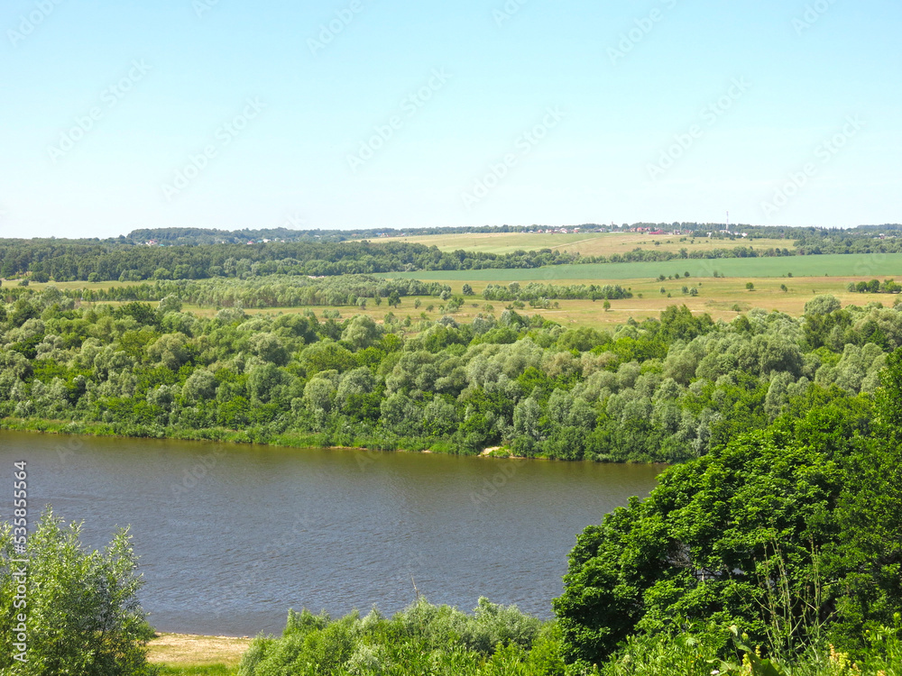 summer panorama of the Oka River with hills, fields and trees along the banks