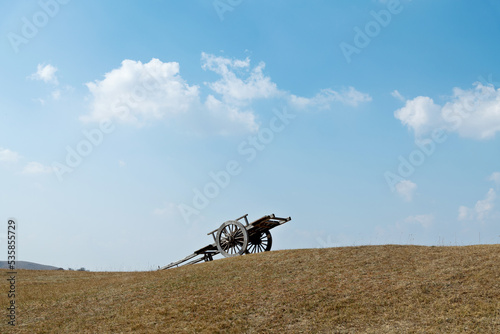 Fototapeta Naklejka Na Ścianę i Meble -  Wooden cart on top of hill
