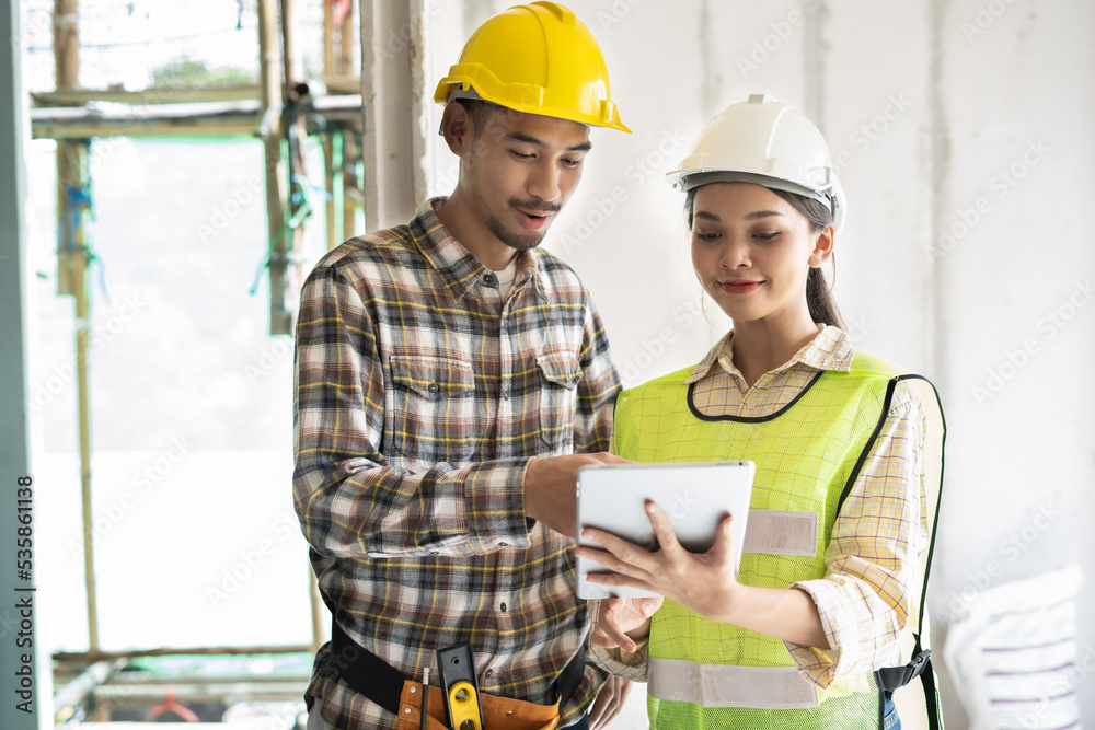 Team of worker inspector or engineer is checking audit and discussing plan to renovation the building or house by touchpad as Inspection and Engineering concept Team of worker inspector or engineer is checking audit and discussing plan to renovation the building or house by touchpad as Inspection and Engineering concept