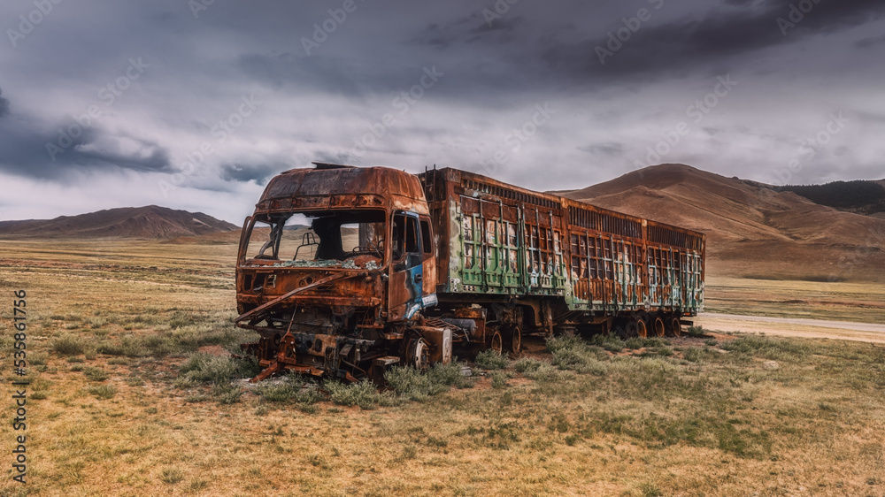 a burnt-out truck in the field. Burnt abandoned car