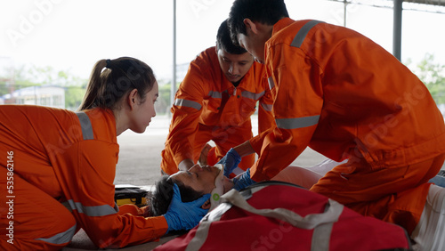 Emergency medical technician Asian woman (EMT) or paramedic team is holding manual stabilization of the head patients, Emergency medical services (EMS) nurses concept photo