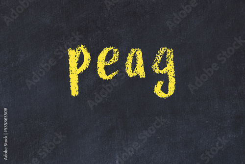 College chalk desk with the word peag written on in photo