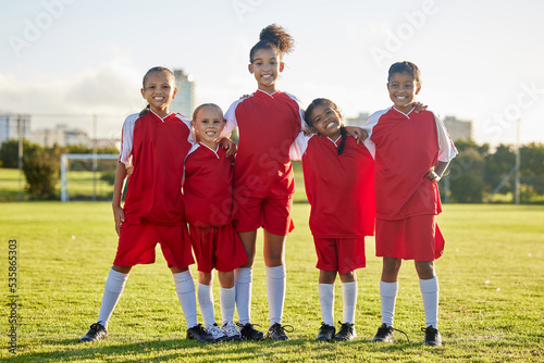 Girl team, kids on soccer field and sports development for happy girls in group portrait together. Teamwork, football and proud female children from Brazil on grass before football game or training.