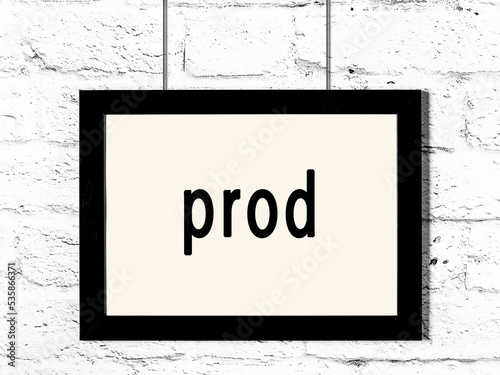 Fotografia Black frame hanging on white brick wall with inscription prod