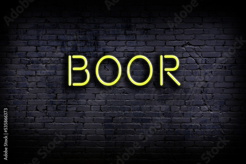 Neon sign. Word boor against brick wall. Night view photo