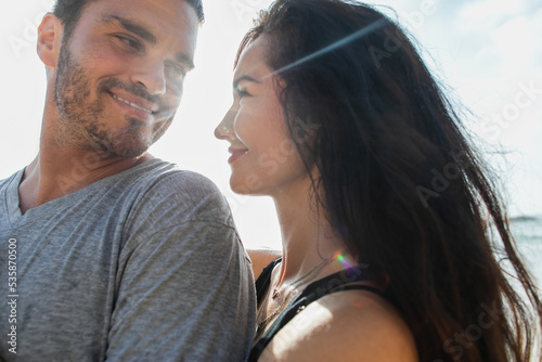 portrait of cheerful woman looking at happy and bearded boyfriend. © LIGHTFIELD STUDIOS