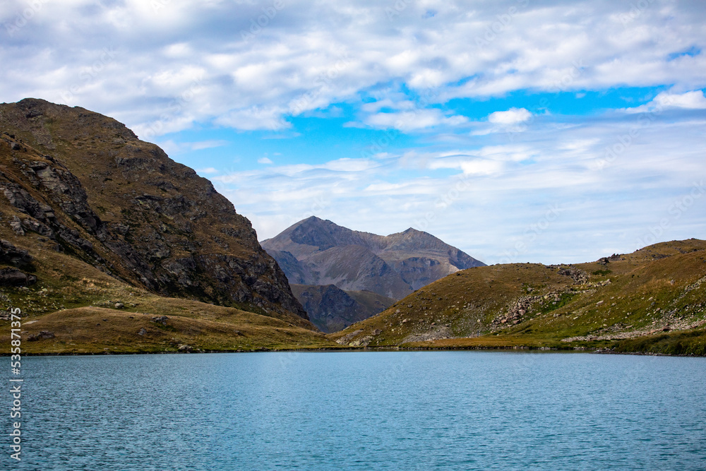 View of a blue mountain lake in the Caucasus Russia against the background of impressive steep mountain peaks View of a blue mountain lake in the Caucasus Russia against the background of impressive steep mountain peaks