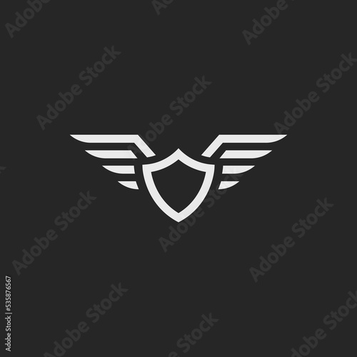 Shield with wings icon vector design. Motorcycle logo inspiration. Simple icon badge wings isolated on dark background.