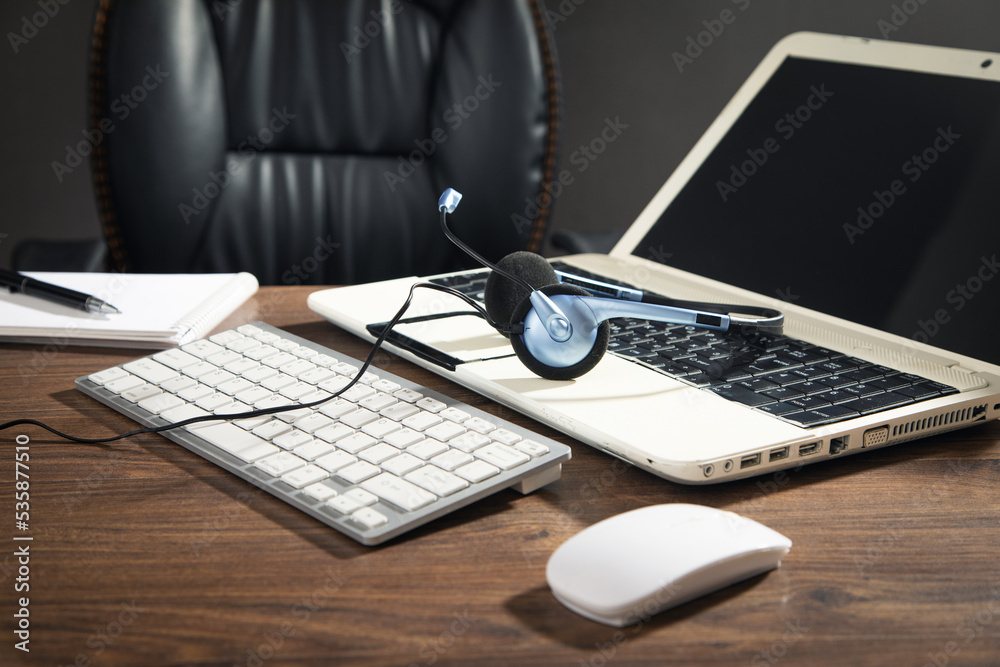 Customer service headset, computer keyboard and business objects on the table. Customer service headset, computer keyboard and business objects on the table.