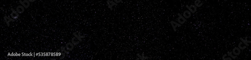 Panorama of the winter night sky and a star on a dark background. Long exposure photo.