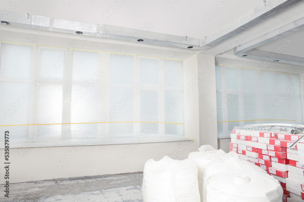 Window covered with polyethylene film. Protection during repair