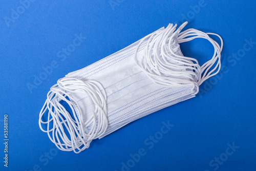 A set of disposable medical masks on a blue background