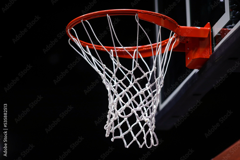 Shallow depth of field (selective focus) details with a basketball panel and net before an official game.