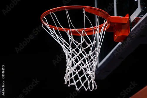 Shallow depth of field (selective focus) details with a basketball panel and net before an official game.