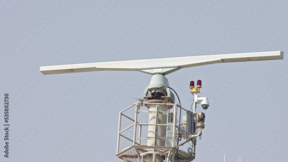 Spinning rotating radar equipment on top of a ship - in front of the sky Spinning rotating radar equipment on top of a ship - in front of the sky