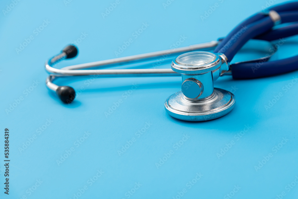 Close up of stethoscope on blue background Close up of stethoscope on blue background