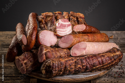 Assorted meat products including ham and sausages. ariety of processed cold meat products. top view photo