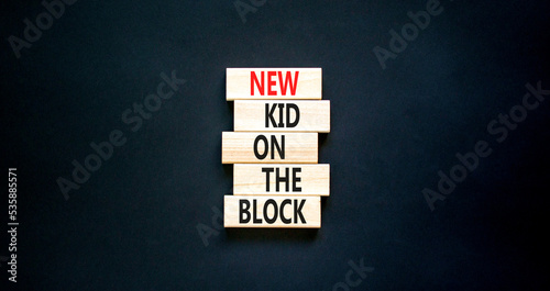 New kid on the block symbol. Concept words New kid on the block on wooden blocks. Beautiful black table black background. Business and new kid on the block concept. Copy space.