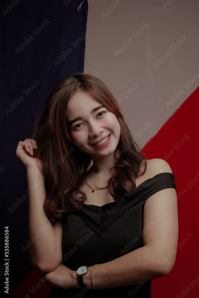 Young Asian women wear dresses or dark clothes. Take pictures and express themselves inside the indoor studio. Young Asian women wear dresses or dark clothes. Take pictures and express themselves inside the indoor studio.