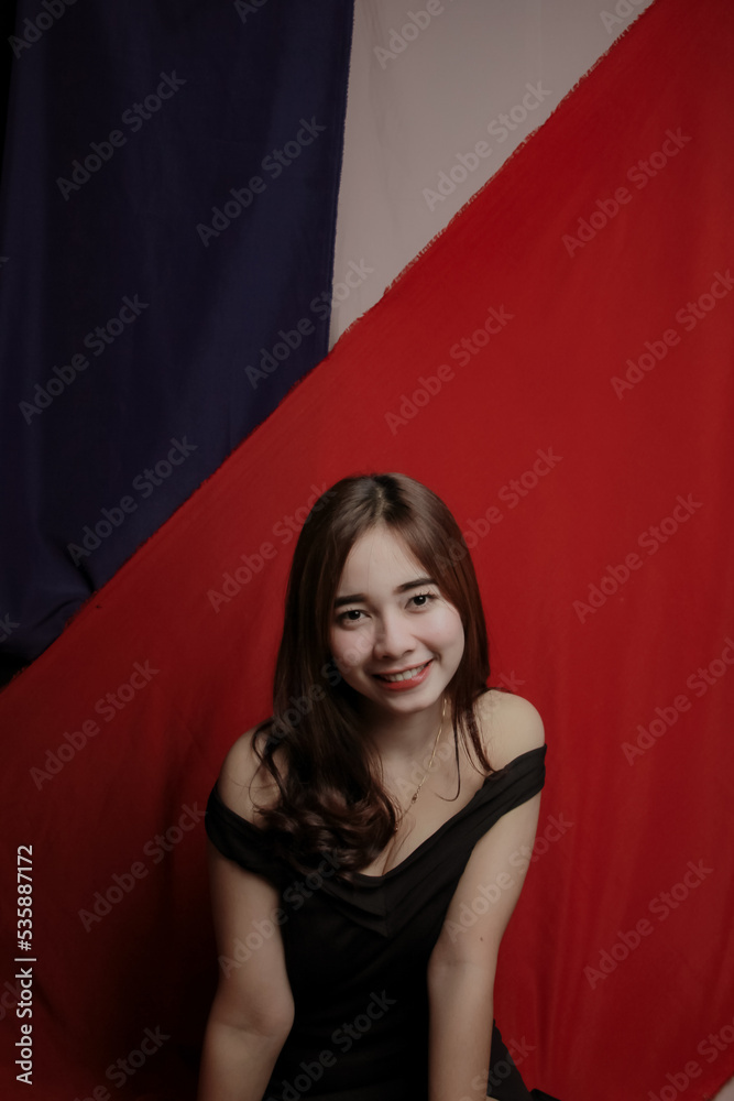 Young Asian women wear dresses or dark clothes. Take pictures and express themselves inside the indoor studio. Young Asian women wear dresses or dark clothes. Take pictures and express themselves inside the indoor studio.