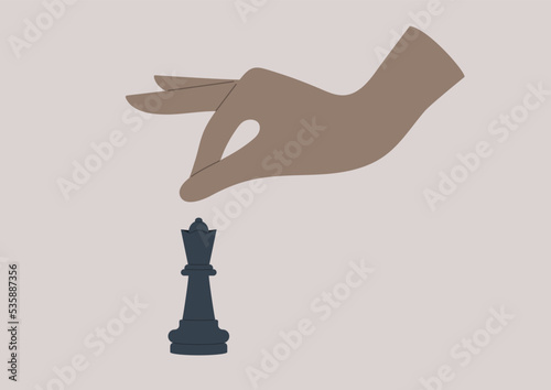 Chess game, a hand reaching out to a black Queen piece