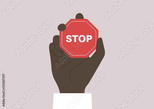 A hand holding a red octagonal stop sign, restricted actions, no racism policy