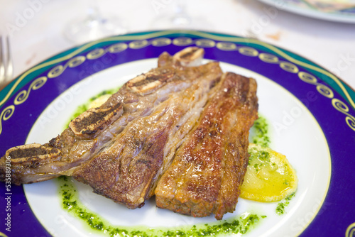 Beef churrasco with garlic and parsley sauce on blue plate Spain