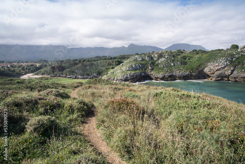 Llanes at North of Spain at Asturias region is an amazing place for enjoying the outdoors with amazing wild and green beaches like this panoramic view of Poo beach