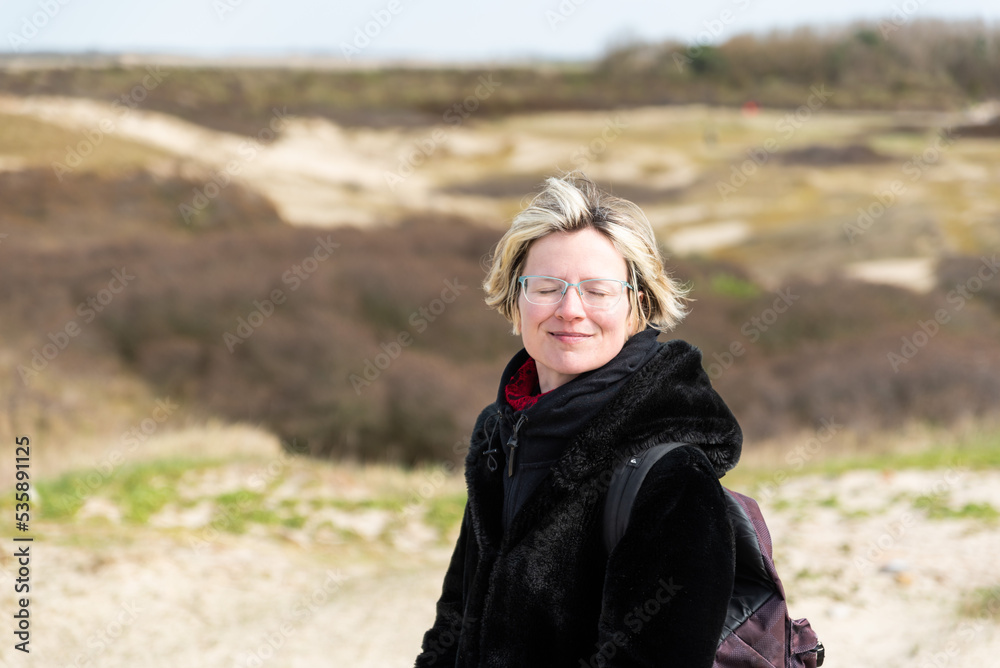 Thirty year old woman posing with the dunes in the background Thirty year old woman posing with the dunes in the background