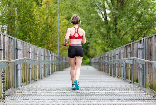 Photos Outdoor female runner, taken from her back