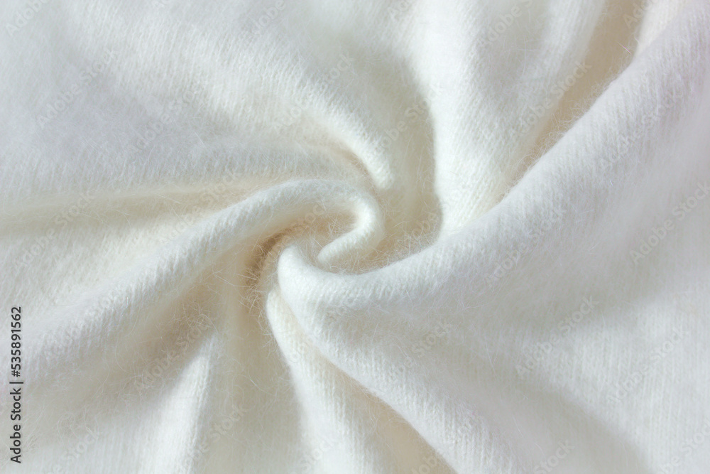 Swirl Background texture of white pattern knitted fabric made of angora and wool close up.