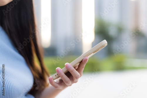 Woman use of mobile phone at park